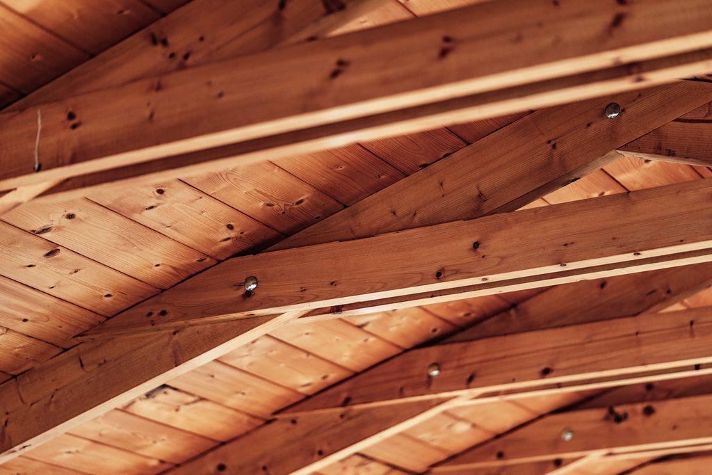 Underside of a wooden roof deck and rafters, the area an inspector checks for leaks from the attic